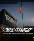 Dorman building with American flag, showcasing "American Company, Global Presence. Driving New Solutions for Over 100 Years."