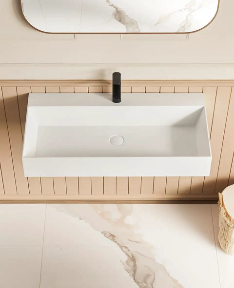 HAOCHRYSYPH Wall Mount Sink, Solid Surface, Matte White, 36 x 18 in. Top view of rectangular sink with black faucet.
