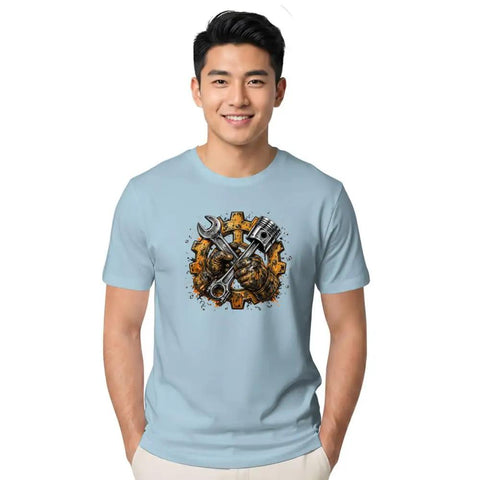 Rugged Garage Project T-Shirt With Vintage Piston Wrench And Gear Badge Design For Hardcore DIY Builds, Engine Repair Work, And Weekend Shop Creations Featuring Distressed Vector Graphics On Mens Heavyweight Cotton, worn by smiling man in light blue, featuring vintage graphic.