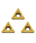 Front view of 3 gold carbide TCMT21.51 turning inserts with central mounting hole.