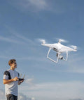 Man flying drone with Phantom 4 Pro Series Beefed Up Battery Replacement 5870mAh Intelligent Flight Battery Pack For DJI Phantom 4 Drones