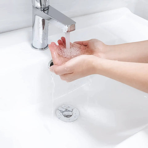 Hands washing over sink with Bathroom Sink Stopper For 1.1 To 1.5 Inch Drains, Bullet Core Push Type Pop Up Basin Drain Filter visible