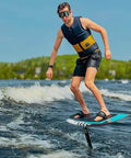 Man wearing Frameless Ultralight Black Mirror Swim Goggles With VisiClear Nanotech Anti Fog Lens And 100 Percent UV Protection surfing on water