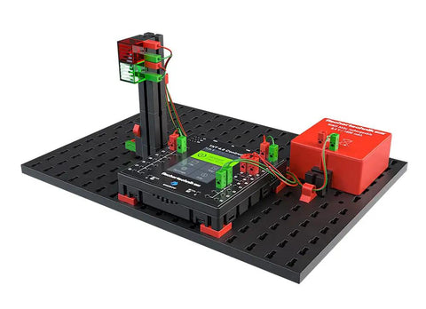 Robotics TXT 4.0 Base Set Robot Kit For STEM Builders, Programmable, Durable Black Design, Hands On Coding And Control, Great For Learning Core Robotics And Engineering. Black robotics kit on perforated base with controller, sensor tower, and red module.