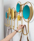 Built Different Wall Mounted Coat Hooks For Entryway with colorful circular accents, hanging bags, sleek gold finish.