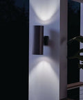Outdoor Cylinder Wall Mount Sconce With Up And Down Lighting In White Finish, 2 Light Exterior Fixture on patio wall at night