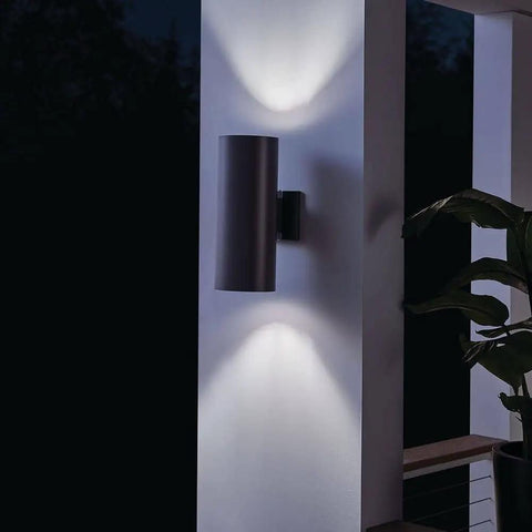 Outdoor Cylinder Wall Mount Sconce With Up And Down Lighting In White Finish, 2 Light Exterior Fixture on patio wall at night