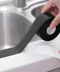 Hand holding Gotcha Check Out This Durable Shower Sink Bath Wall Caulk Sealing Strip Tape With An Anti Stain Self Adhesive Design.