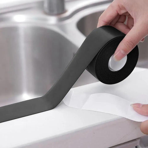 Hand holding Gotcha Check Out This Durable Shower Sink Bath Wall Caulk Sealing Strip Tape With An Anti Stain Self Adhesive Design.