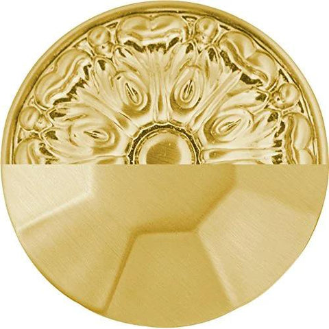 Close-up of a decorative solid core cabinet pull in brushed golden brass finish, showcasing intricate design.