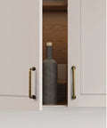 10 Pack Antique Brass Cabinet Bar Pulls 3 Inch Center To Center for kitchen cupboard with open doors showing bottle.