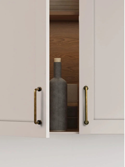 10 Pack Antique Brass Cabinet Bar Pulls 3 Inch Center To Center for kitchen cupboard with open doors showing bottle.