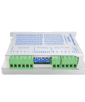 DM556Y digital stepper motor driver, white metal enclosure with green terminal blocks and blue DIP switch (front view).