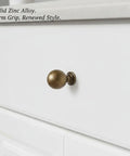 Antique Bronze Zinc Alloy Cabinet Pulls For Kitchen Cabinets, Drawers, And Dressers with firm grip on white drawer.