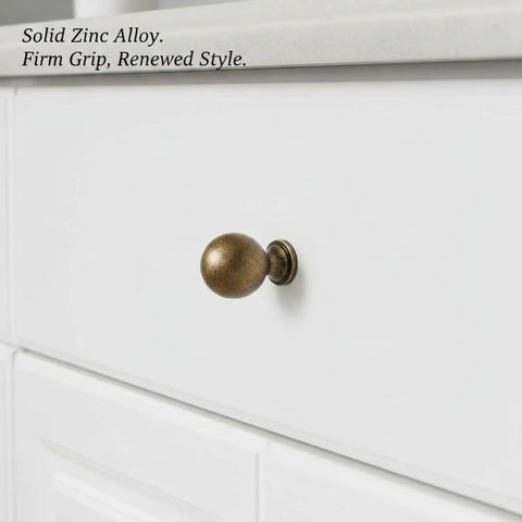 Antique Bronze Zinc Alloy Cabinet Pulls For Kitchen Cabinets, Drawers, And Dressers with firm grip on white drawer.