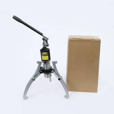 Thinking Process: hydraulic bearing puller kit with steel jaws, hand pump, and box for workshop use