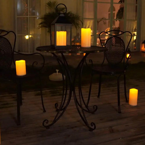 Outdoor Flameless Candles 8 by 4 Inch Waterproof Pillar Set of 2 with Remote Control illuminating a porch table.