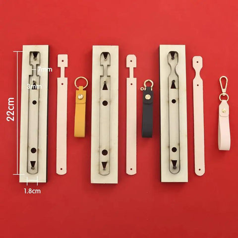Three Piece Long Keychain Cutting Mold Set With Dog Paw Pattern Punch Tool for DIY Leathercraft, shown with key fob straps.