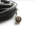 Pro Grade Nylon Braided Airbrush Hose Extending One Point Eight Meters Long featuring shiny one-eighth male connector and black braid.