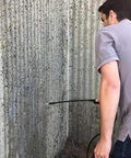 Person applying Straight Fire Block Sealer 1 Gallon Clear Penetrating Silane Siloxane Formula on textured concrete wall.