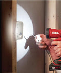 Person using Ultra Bright Led Work Spotlight Rechargeable 20 Volt Cordless 300 Lumens Portable Jobsite Light on a wall socket.