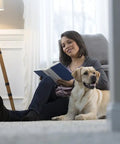 Woman reading on the floor with her dog, showcasing clean carpet maintained with 22oz Spot Remover With Sprayer Handle White No Oxy Stain Remover.