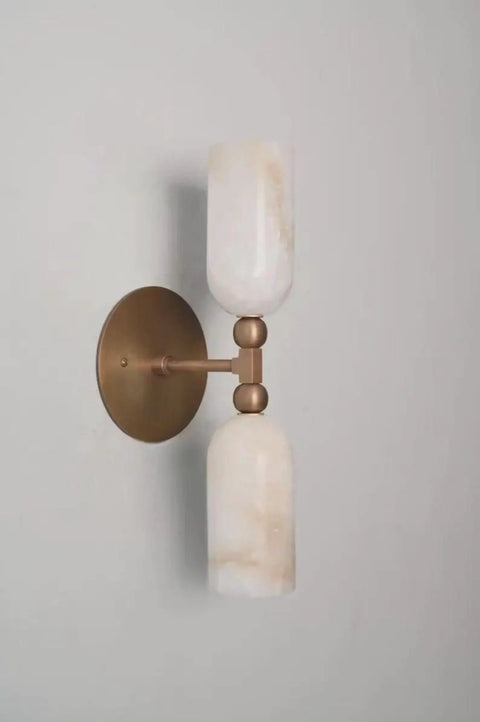 Alabaster Wall Sconce Lighting, Brass Wall Light Fixture with Natural Stone Shade in a modern hallway setting.
