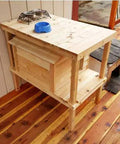 Chillin In Style With Your Favorite Feline Pal This Elevated Cedar Cat House Packs Serious Insulation And A Raised Two Level Loft To Keep Outdoor Pets Cozy Dry And Protected, showing a wooden elevated cat house with food bowls.