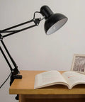 Heavy Duty Desk Lamp Swing Arm Clamp Set Of Three Non Marring Plastic Bracket Holder in use, illuminating an open book on desk.