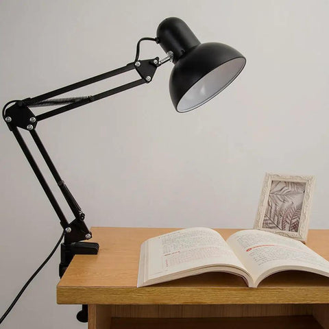 Heavy Duty Desk Lamp Swing Arm Clamp Set Of Three Non Marring Plastic Bracket Holder in use, illuminating an open book on desk.