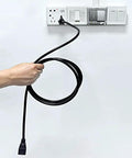 Hand holding black Outdoor Extension Cord 10 Ft Heavy Duty 3 Prong Waterproof Cord UL Listed Black for Indoor and Outdoor Use