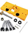 Door hinge drilling jig kit with yellow plastic base and five metal drill bits, plus Allen key.