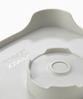 Close-up of Wash And Drain Kitchen Dish Tub With Handles And Twist Drain Plug 9 Liter Basin, focus on built-in plug and strainer detail