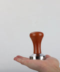 51mm Espresso Tamper With Stainless Steel Flat Base And Solid Wood Handle For 51mm Portafilters, held on a hand
