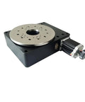 Slick High Precision Motorized Rotary Positioning Stage Delivering Buttery 360 Degree Rotation With Tight Worm Gear Mechanics And A Solid 100 Millimeter Indexing Base For Dead Center Performance viewed from an angle, showing metal surface and motor.
