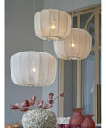 Nordic Apartment Pendant Light Cozy Handmade White Fabric Lantern Ceiling Hanging Lamp Minimalist Chandelier Imitation Silk Lampshade Modern Hanging Light With E26 Base For Dining Room Kitchen Cafe Restaurant over a table with flowers.