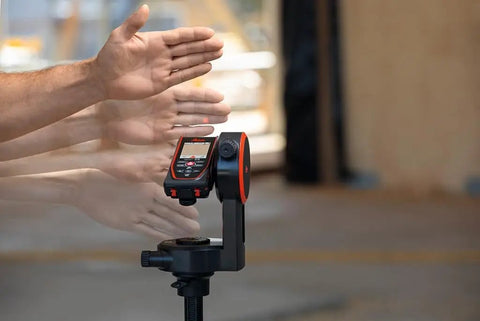D5 Laser Distance Meter With Bluetooth 650 Ft Range Built In Pointfinder Camera 4X Zoom Remote Measuring on tripod with hands nearby