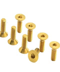 Pro Level M3 Gr5 Titanium Alloy Flat Countersunk Hex Socket Set Screws Coated In Durable Rainbow Finish For Snug Fits And Rapid Project Buildouts On Any Rig Or Machine Setup. Gold screws with countersunk heads in a group.