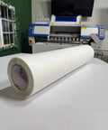 DTF Transfer Film Roll Hot Peel 24x328ft Clear PET Heat Transfer Paper, roll positioned on table in printing setup