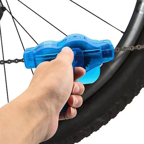 Hand using Bike Chain Cleaner Kit 4 Piece Set For Quick Clean And Deep Scrub Gear Brush Included Built Tough For Mountain Bikes And All Bicycle Chains Perfect Maintenance Tool For Weekend Riders on mountain bike chain