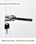 Sliding Glass Door Ratchet Lock For Display Cases With Chrome Finish, mounted on glass with key inserted, close-up view.