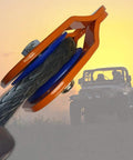 Beefy Heavy Duty Snatch Block For Winches With Synthetic Rope, Off Road Recovery Pulley, 29,000 Lb Max Load, Orange Color, Rugged Durable Pulley Block For Vehicle Recovery And Winching, orange snatch block with synthetic rope on off-road Jeep