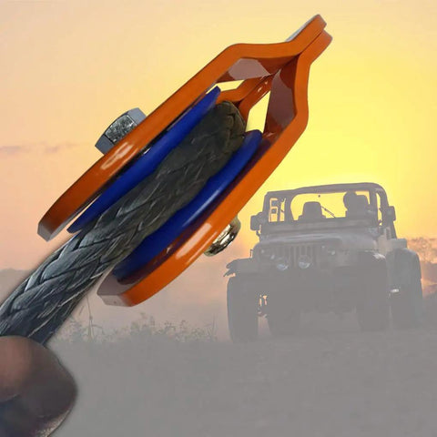 Beefy Heavy Duty Snatch Block For Winches With Synthetic Rope, Off Road Recovery Pulley, 29,000 Lb Max Load, Orange Color, Rugged Durable Pulley Block For Vehicle Recovery And Winching, orange snatch block with synthetic rope on off-road Jeep