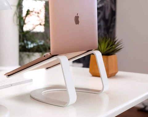 White T Molding Roll 1 1/4 X 100 Foot Straight Up Tough Flex Polyethylene Edge Banding For DIY Furniture Arcade Cabinets And Game Tables Cut To Fit Center Barb Tee Trim Built To Last With No Sweat Installation Made In Usa on a desk with a laptop stand.