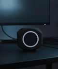 Total Game Changer Acoustic Foam Mic Windscreen Pop Filter Stops Plosives Kills Background Noise For Podcasting Streaming And Home Broadcast Perfectly Shields Your Mic With Thick Black Foam Cover on a desk with computer monitor