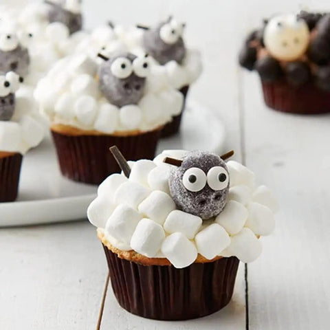 Cupcakes decorated with Big Edible Candy Eyeballs 10 Mm for bold decorating, resembling sheep with marshmallow frosting.