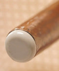 Peel And Stick Furniture Sliders Value Pack For Carpet Floors on a wooden chair leg, showing a white protective cap for easy movement.