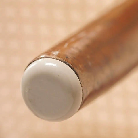 Peel And Stick Furniture Sliders Value Pack For Carpet Floors on a wooden chair leg, showing a white protective cap for easy movement.
