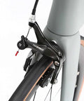 Close-up of brake system on Toray T800 Carbon Frame Road Bike Model H With Tiagra 20 Speed Drivetrain, Ultra Lightweight, Celeste Finish.