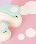 3 Inch Circle Scallop Punch With Easy Lever Press for scrapbooking DIY cards, showing scalloped cutouts on pink surface